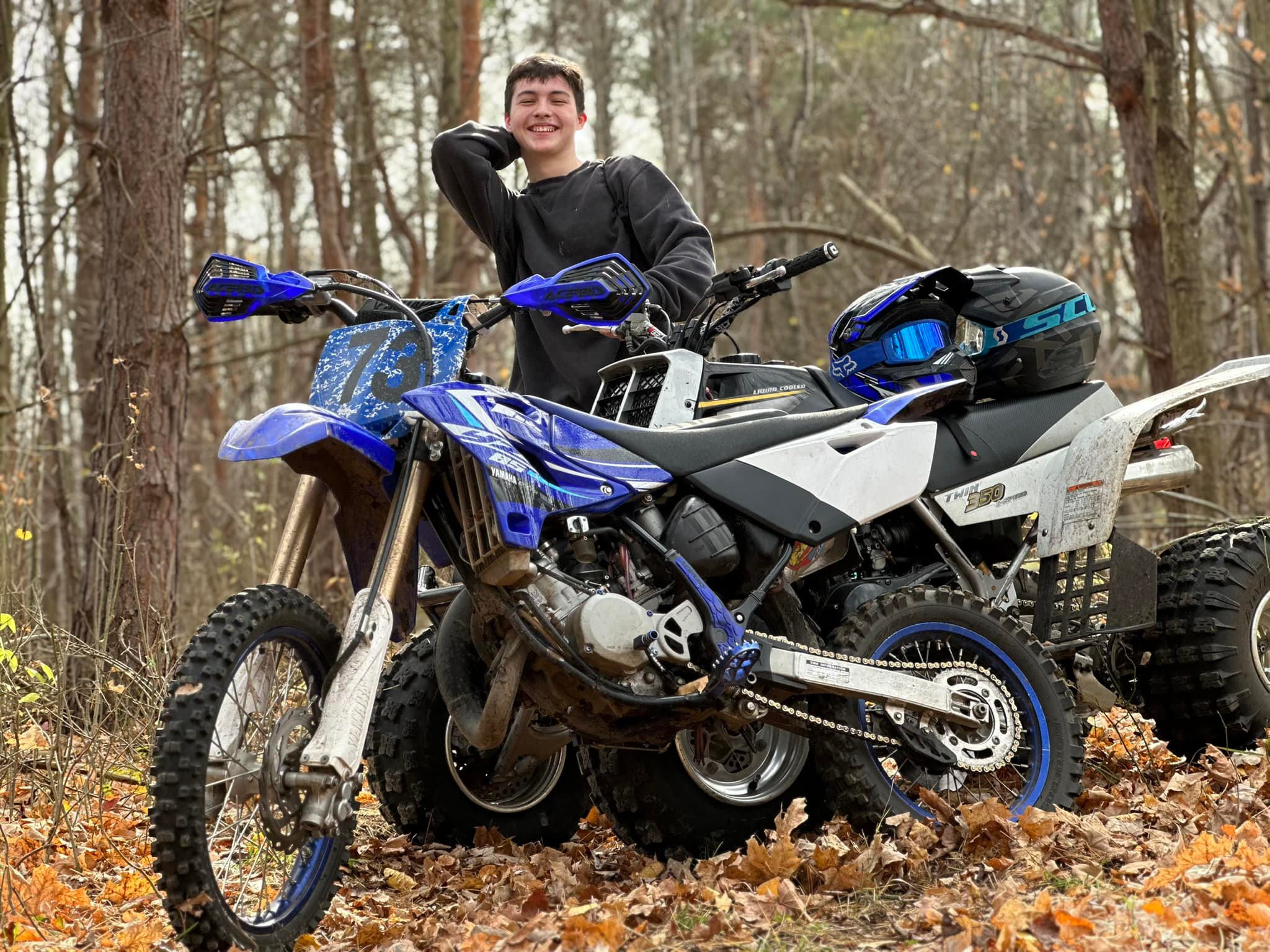 Jaxon Wright with machines in the woods